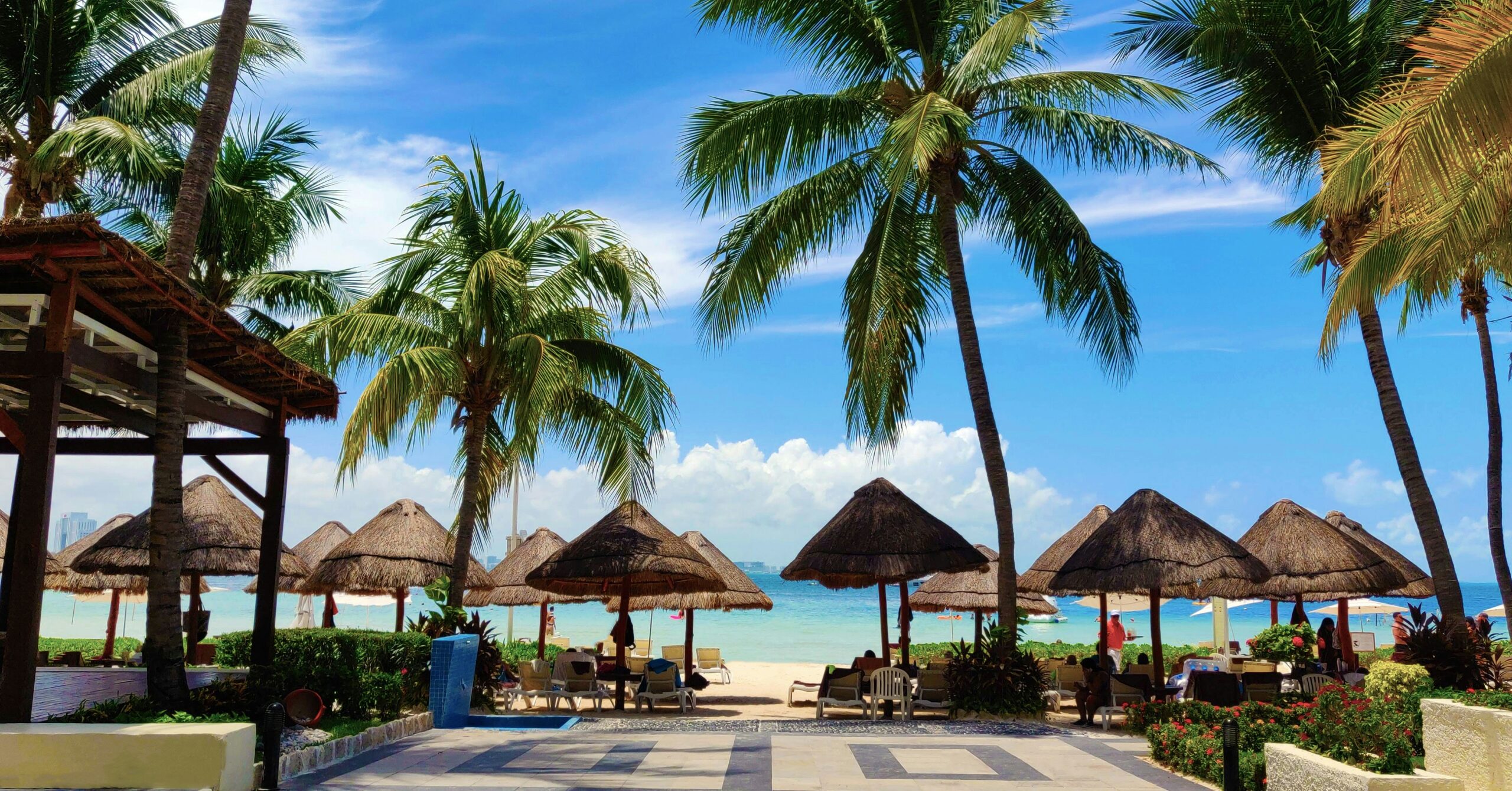 a beach with umbrellas and chairs