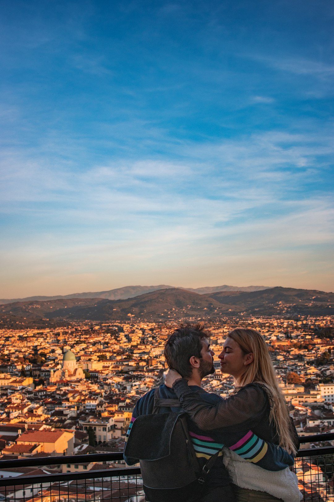Pareja contemplando un paisaje desde una colina